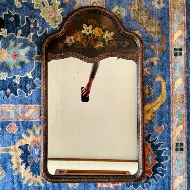 Lovely antique gilded mirror with hand painted floral design on the top panel. Moody color palette. Original mirror with...