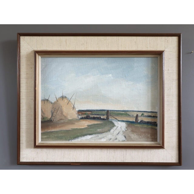 HAYSTACKS BY THE GATE Size: 14.6 x 18.1 inches (including frame) Oil on board A charming mid-century landscape that...