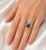 This 18K white gold ring features hand-cut natural sapphires, brilliant round champagne diamonds, and 2 round natural...