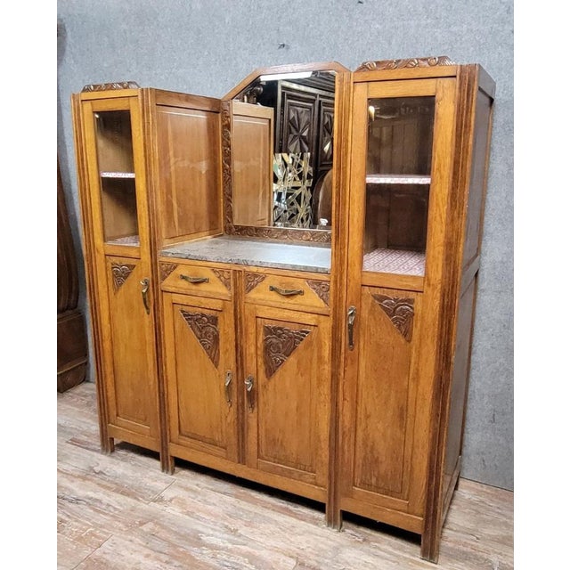 Art Nouveau oak two-part display cabinet, circa 1900. The front opens with four doors, two of which are glazed, and two...