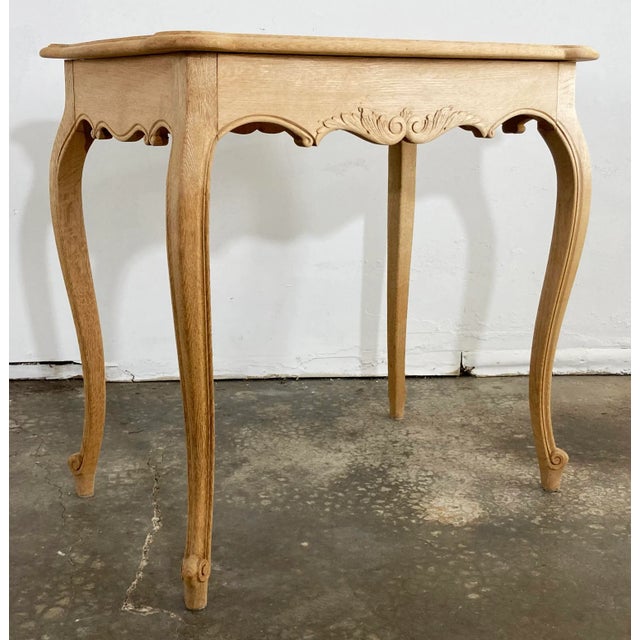 Vintage French Louis XV style bleached wood side table with carved apron and turned legs. Reminiscent of 19th C. Hand-...
