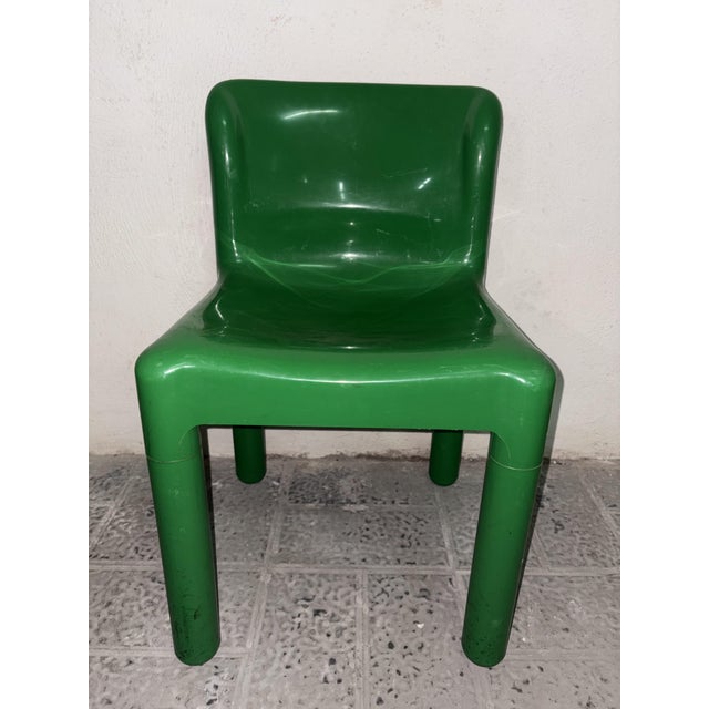 Model 4875 chair in green plastic. The backrest and seat are rounded. The legs are round. Produced by Kartell in 1970 and...