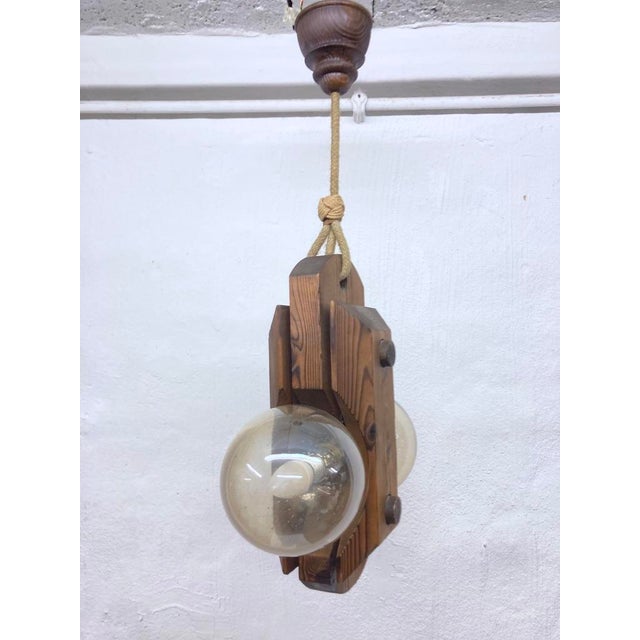 One 1970s pendant lamp, two-light, E14 socket, by Temde. Pine wood, stained, glass. Good used condition with minor signs...