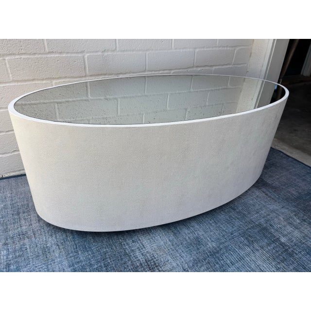 Indoor / Outdoor Cara Oval Coffee / Cocktail Table by Made Goods. White cocktail / coffee table with a speckled mirror....