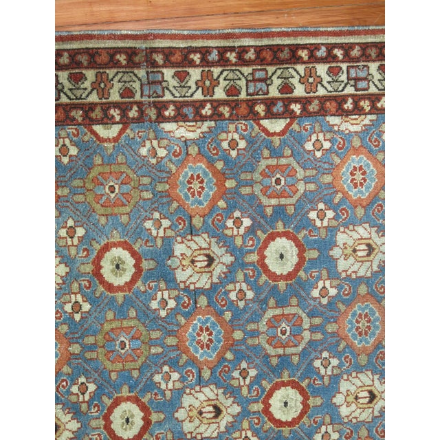 An early 20th century Persian Malayer with a primitive all over design on a blue field. 4'9'' x 6'8''