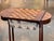 A compact and characterful rosewood game table with a inlaid chessboard top that lifts to reveal a shaped well below. The...
