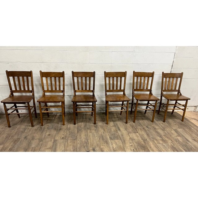 This is a gorgeous full set of six vintage oak slat back pub chairs or dining chairs with elements of Mission Arts and...