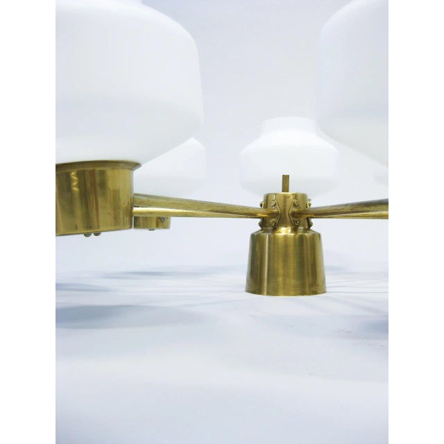 This ceiling lamp was produced by Asea and is made of brass and glass. The piece is in the style of Hans Bergström....