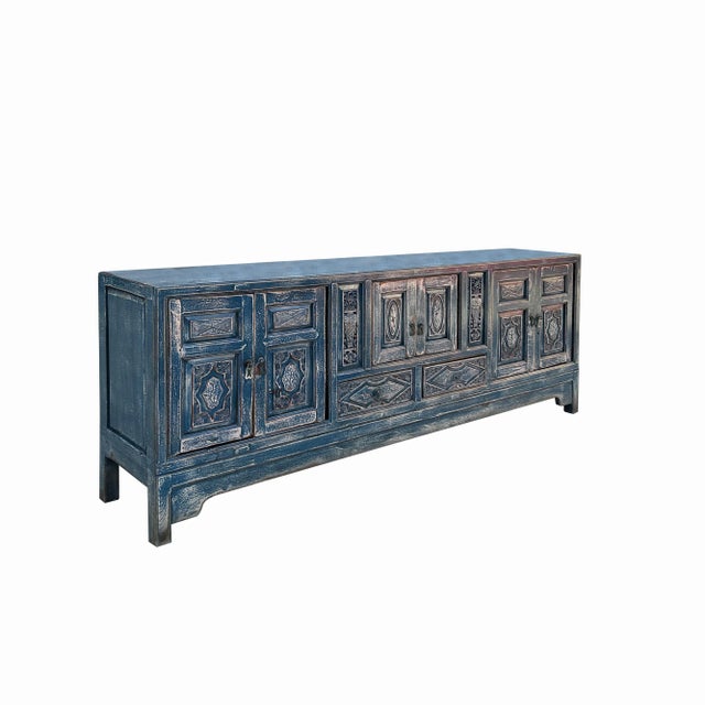 This is a low console sideboard cabinet with oriental relief carving of vases and flowers on the doors and the front. The...