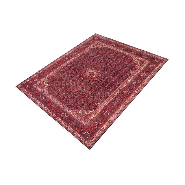 Hand-knotted wool rug measuring approximately 6.11 x 10.1 feet. This elegant carpet features a deep blue field with an...