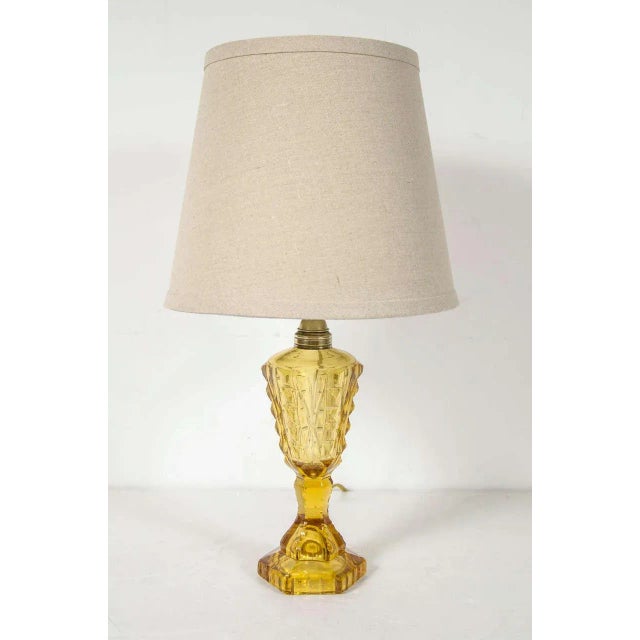 This very elegant lamp features an exquisitely cut balustrade form with stylized Art Deco detailing and has brass...