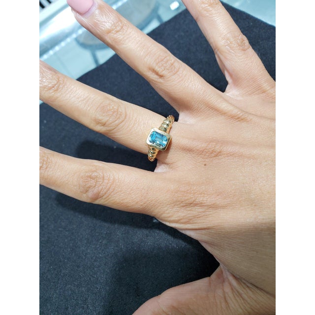 ♥ Product Summary ♥ Main Stone: Blue Topaz Band Material: 14k Yellow Gold Dimensions: 9mm (height) Stone Cut: Emerald