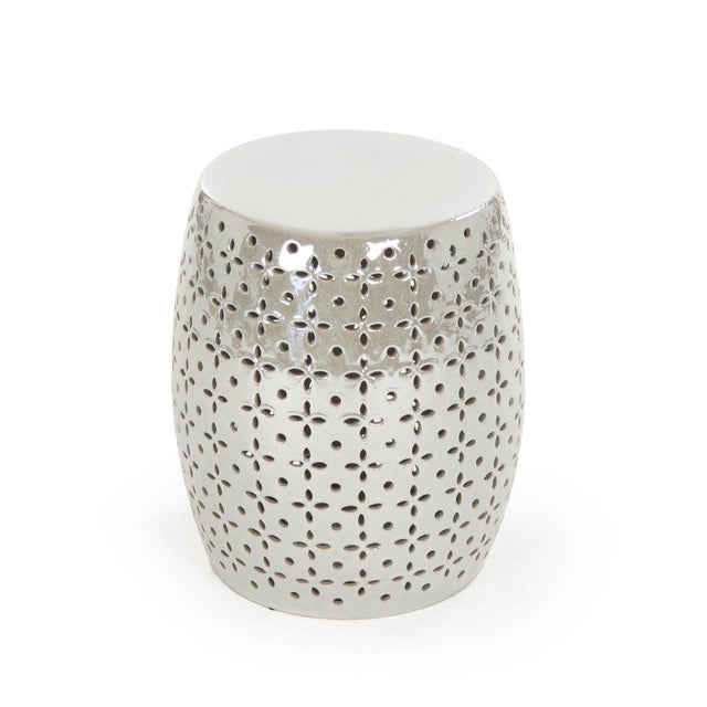 The Lovell Garden Stool is a ceramic garden stool with a barrel form and a delicate petal-flower pierced pattern in a...