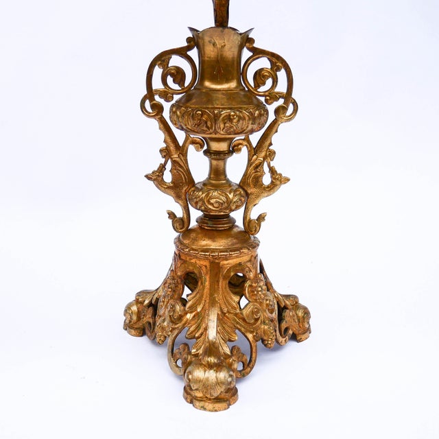 A spectacular pair of 19th-century church candelabras, made of embossed and gilded metal. Each piece rests on an openwork...
