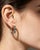 Elegant 14K white gold hoop earrings featuring 6 natural oval emeralds and 16 brilliant round diamonds totaling 0.2...