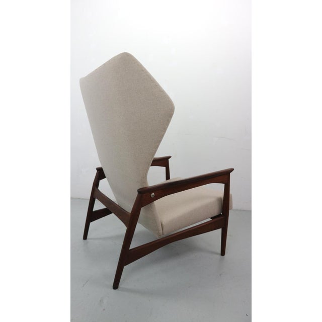 Wingback lounge chair designed by Ib Kofod-Larsen in 1954. The chair is reclinable and it can be adjusted in three...