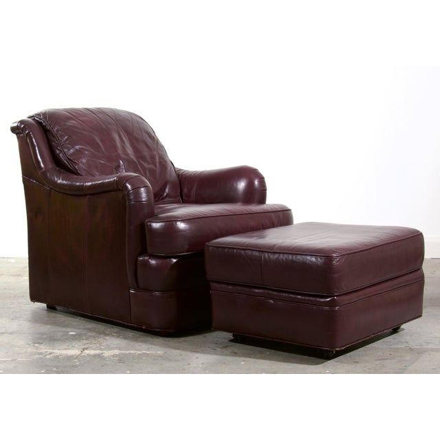 This vintage Whittemore-Sherrill club chair and ottoman are upholstered in rich oxblood leather, with gracefully rolled,...