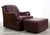 This vintage Whittemore-Sherrill club chair and ottoman are upholstered in rich oxblood leather, with gracefully rolled,...