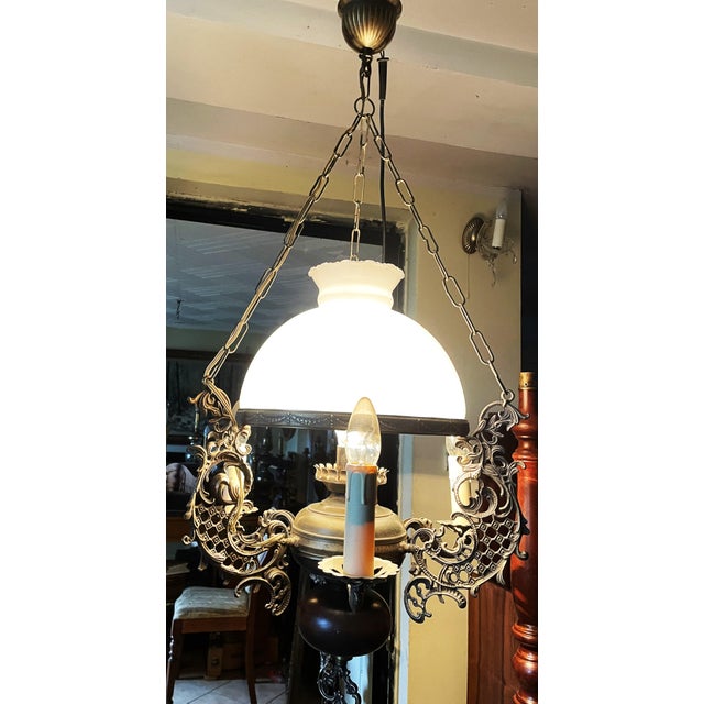 A striking pendant lamp in the Neo-Renaissance/Vintage style. Crafted from brass with decorative openwork elements and a...
