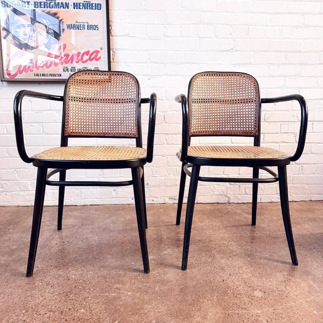Josef Hoffman black bentwood and cane arm chairs, designed for Thonet. This pair of model No.811 chairs is attributed to...