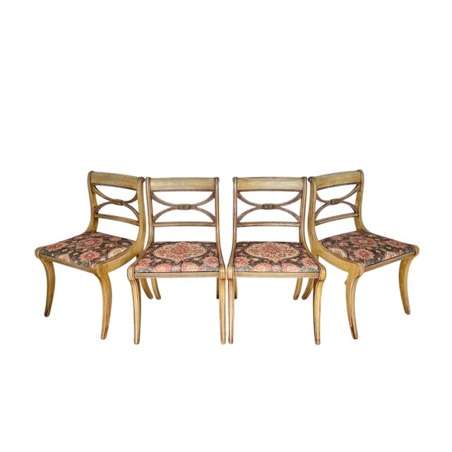A vintage set of four federal style dining side chairs from Drexel's New Travis Court collection circa 1946. These klismos...