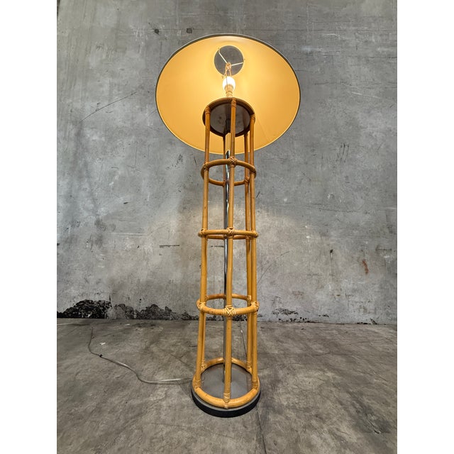 Handsome vintage bamboo and chrome floor lamp with real presence. Eight slender bamboo/rattan poles form an open cage...