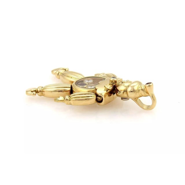 This Chopard pendant charm is crafted in solid 18k yellow gold and features a movable Clown pendant with a crystal case...