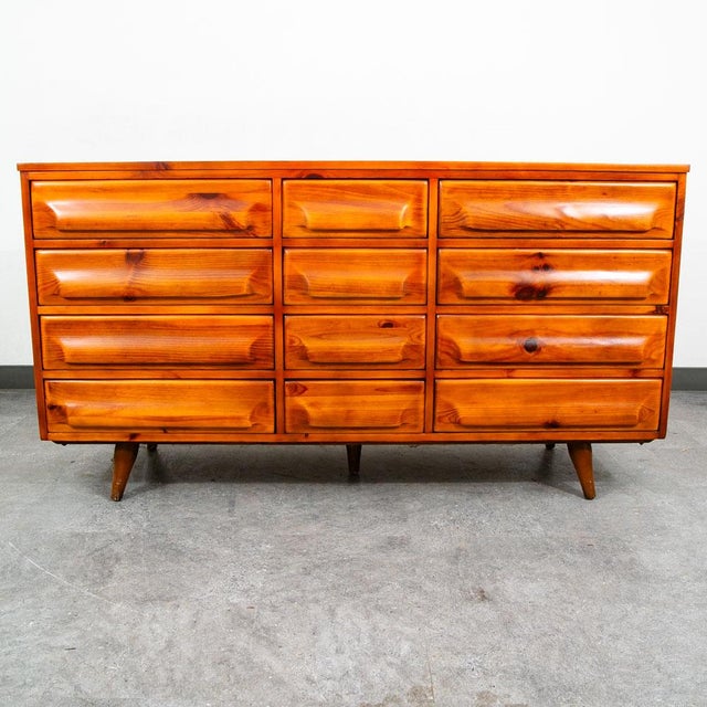 A gorgeous recently restored mid-century organic modern solid sculpted solid knotty pine 12 drawer credenza / dresser by...