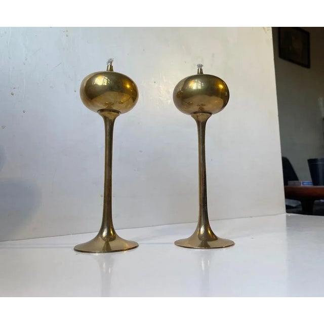 Matching pair of solid brass oil lamps. They feature onion shaped tops and trumpet shaped bases. Manufactured in...