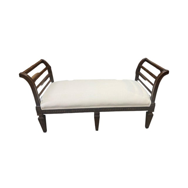 This beautiful bench features elegantly out-scrolled armrests or end-boards with horizontal reeded slats, a carved...