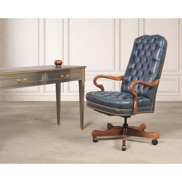 A handsome 20th century English Regency style tall executive office desk chair in an opulent royal blue leather. The...