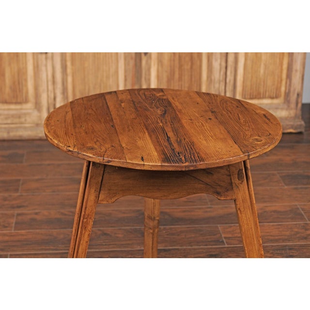 An English pine cricket table from the Turn of the Century, with scalloped apron. Born in England during the early 20th...