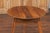 An English pine cricket table from the Turn of the Century, with scalloped apron. Born in England during the early 20th...