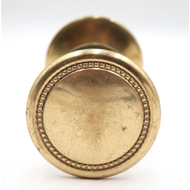 Traditional style brass entry door knob set with a beaded design. Priced as two door knobs, one rosette, and a spindle....