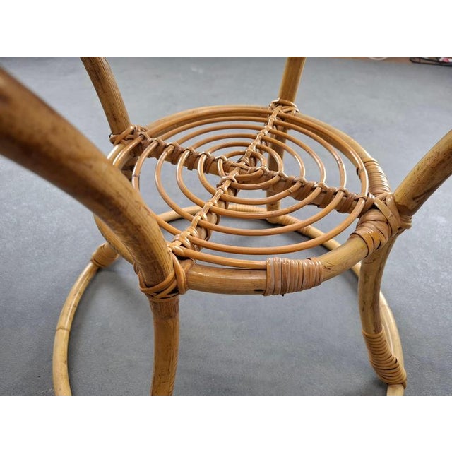 A refined midcentury side table made from bamboo and rattan, produced in Czechoslovakia circa 1960. The design features a...