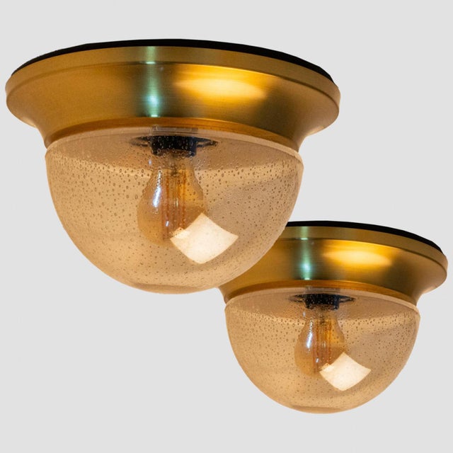 1 of the 2 round amber glass wall lights/flush mounts in the style of Limburg around 1960 in Europe, Germany. The hand-...