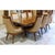 This formal dining set features a richly detailed rectangular table with carved edges and sturdy, sculpted legs. The eight...