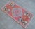 a Vintage Turkish Small yastik rug, pinkish red background rug perfect for entryway, bath or in front of the kitchen sink....