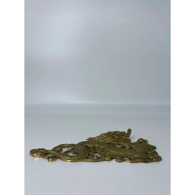 Vintage brass dragon wall hanging. Nine inches long.