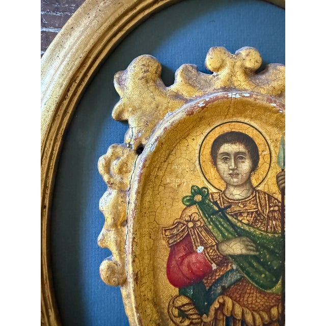 This vintage Orthodox icon depicts Saint Demetrius, the revered warrior saint, shown in traditional military attire...
