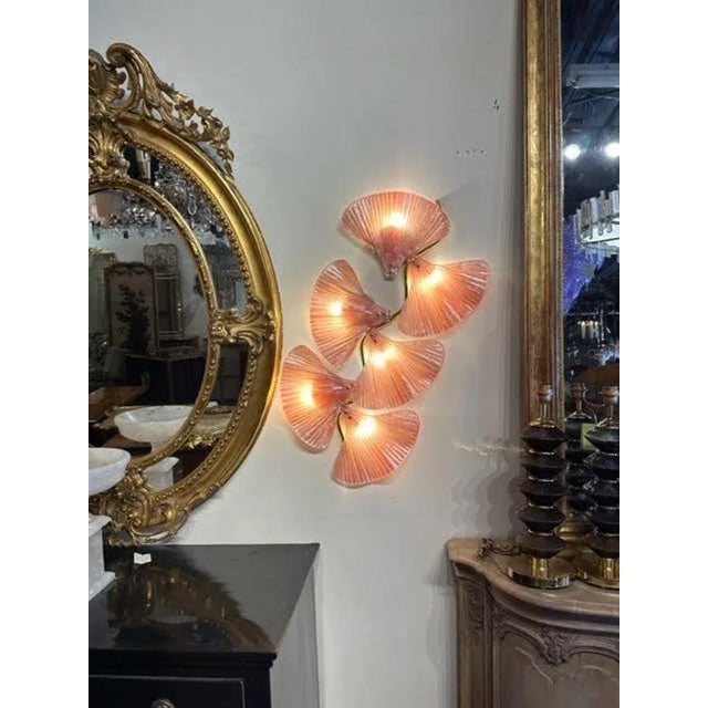 Gorgeous pair of pink Murano glass and brass fan shaped sconces. Creates a fabulous upscale look that is sure to impress!...
