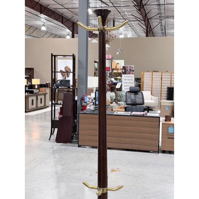 This refined Italian style coat tree presents a beautifully turned wood column anchored by a solid, sculptural round base....