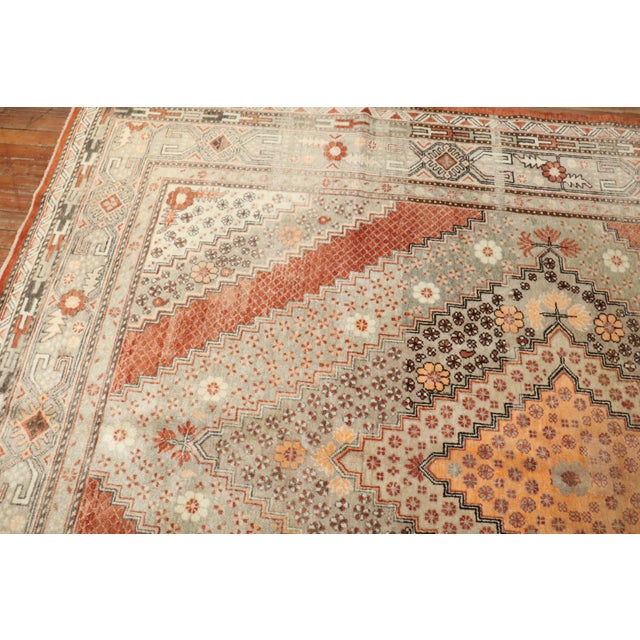 20th century one of a kind gallery size Khotan rug with 2 large medallions on an apricot color ground, dominant accents in...
