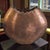 This Mid-Century Modern Arts & Crafts Style Rugged Edge Oval Copper Vase features a unique and artistic design that adds a...