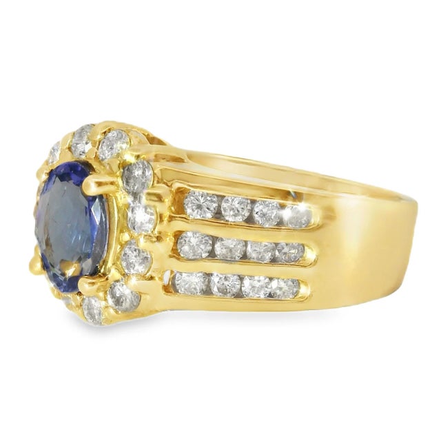Elegant 14K Yellow Gold Tanzanite and Diamond Ring featuring a 7mm natural tanzanite 1ct surrounded by 36 brilliant round...