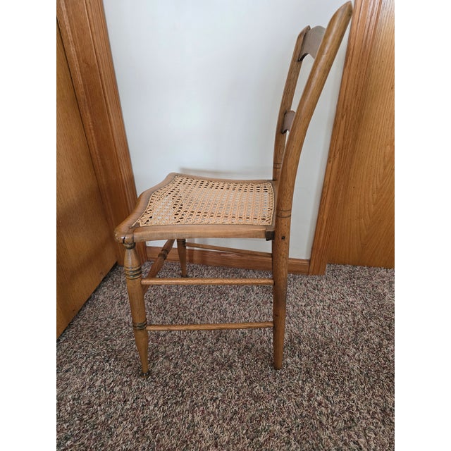 Handcrafted antique maple ladderback chair featuring a beautifully shaped double-rail back and an original hand-woven cane...