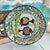 Set of 4 hand-painted Mexican Talavera earthenware plates featuring a colorful dual-fish motif framed by a vibrant green...