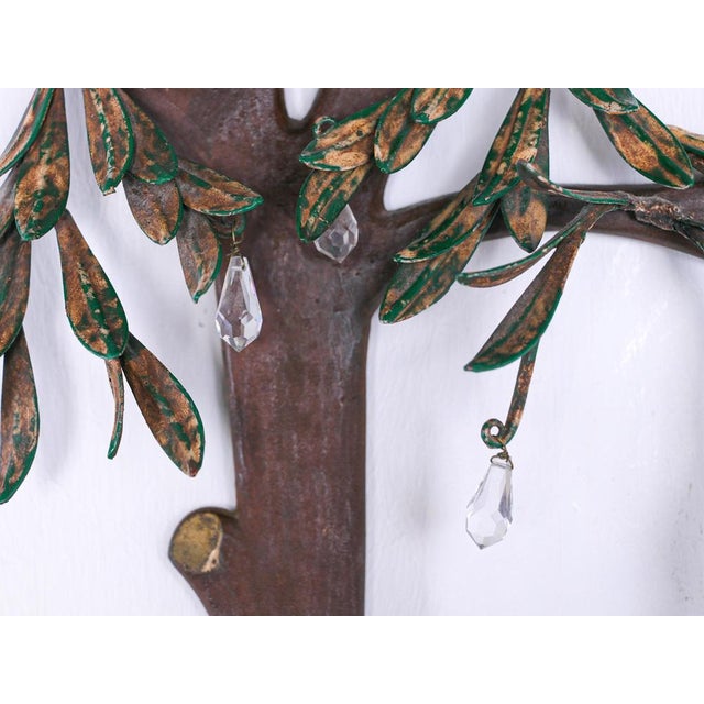 These unique sculptural wall light is naturalistically designed with leafy fruiting branches painted and gilt tole. There...