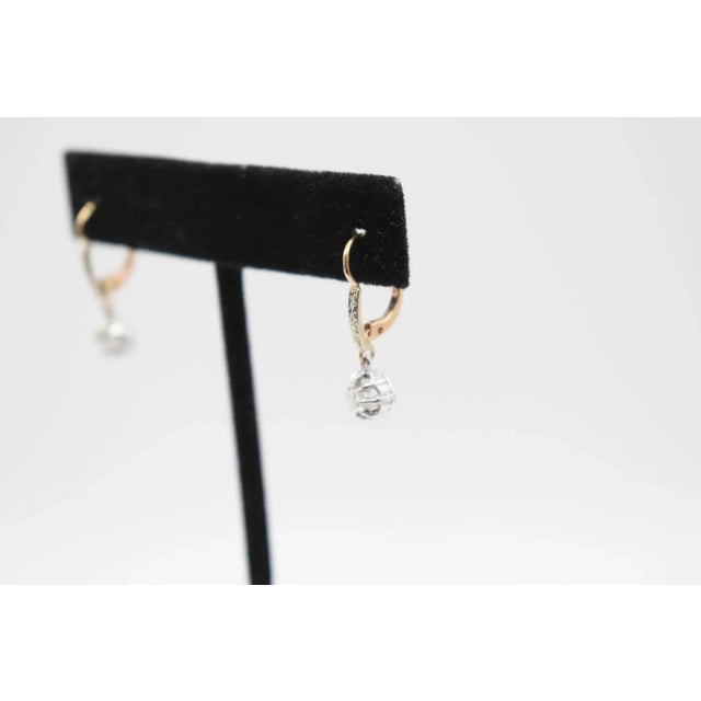 These are beautiful antique diamond dangle earrings. They feature 0.25-0.30 carat diamonds in each earring. They are set...