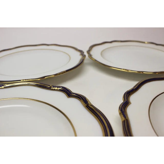 Set of Four English Copeland dinner plates with cobalt blue edges and gilt details. Retailed by Gilman Collamore.